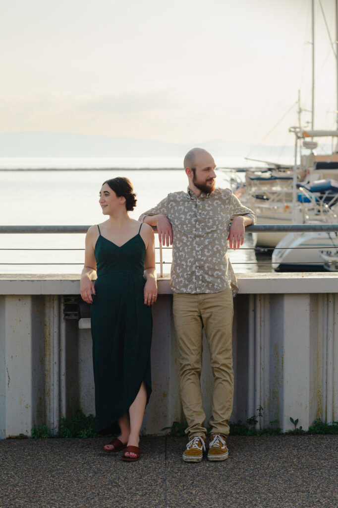 Couple leans on the breakwall at sunset outside ECHO in Burlington, Vermont