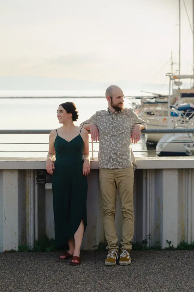 Couple leans on the breakwall at sunset outside ECHO in Burlington, Vermont