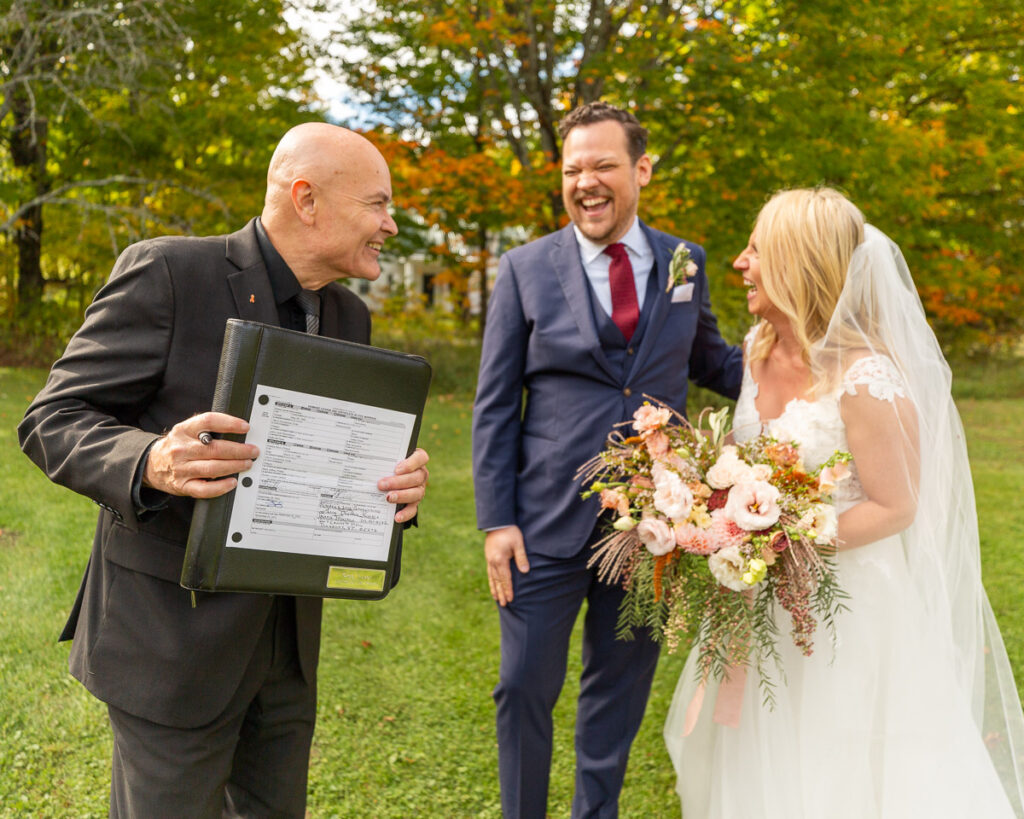 Justice of the Peace, Greg Trulson, showing off a marriage licence with a couple he just married at Turning Stone Farm in Greensboro, Vermont