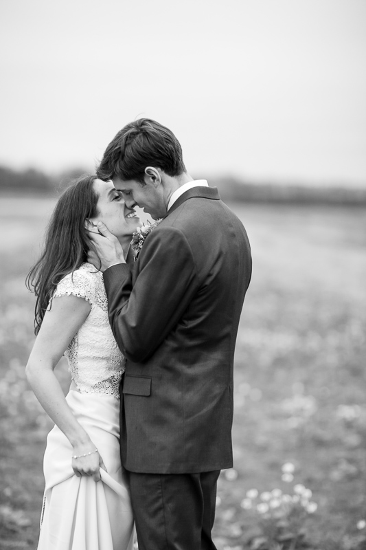 a newlywed couple embraces in an autumn farm field in Ferrisburg Vermont