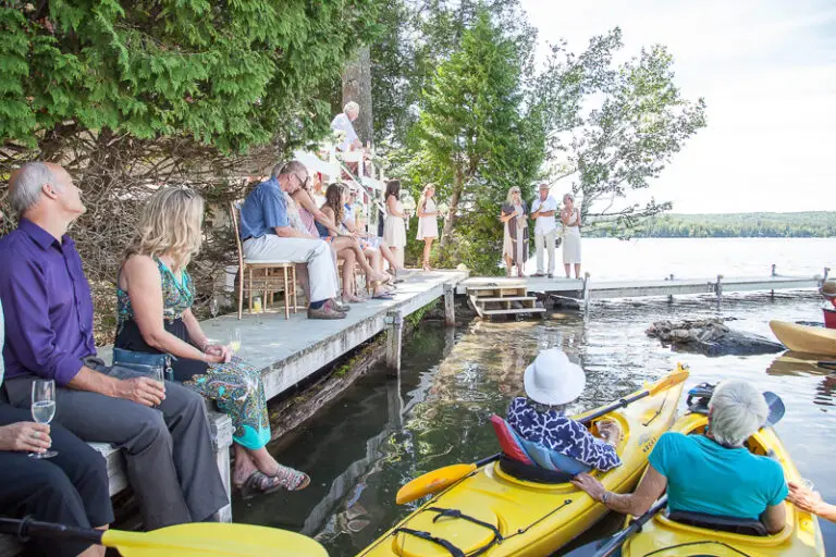 Guests gather for the lakeside ceremony. Some in kayaks some on the dock.