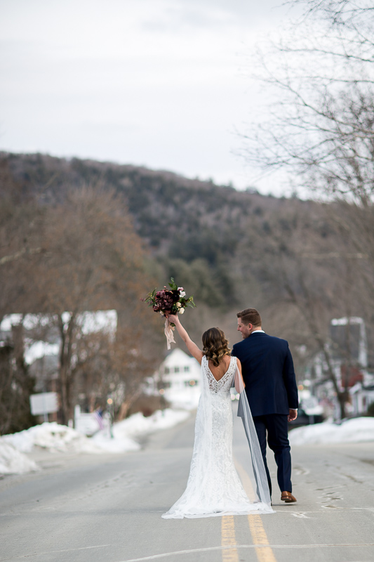 Bride and groom walk down main street Grafton, Vermont