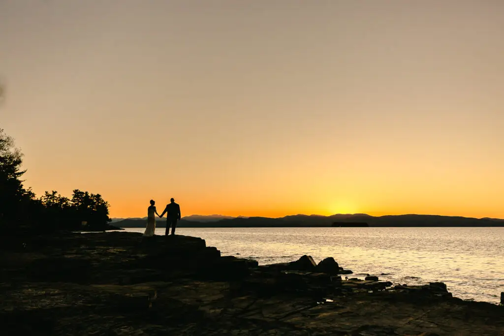 A bride and groom watch the sunset at Oakledge park, Burlington Vermont