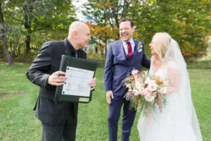 Greg Trulson wedding officiant shows couple their signed wedding license
