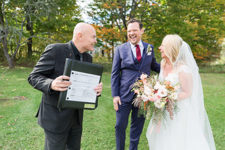 Greg Trulson wedding officiant shows couple their signed wedding license