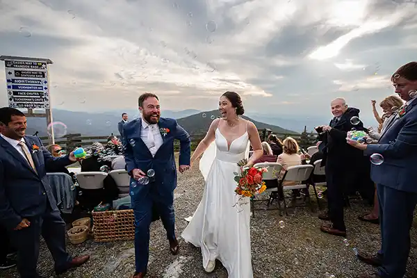Bride and groom share genuine laugh together during Jay Peak Resort Vermont fall wedding celebration.