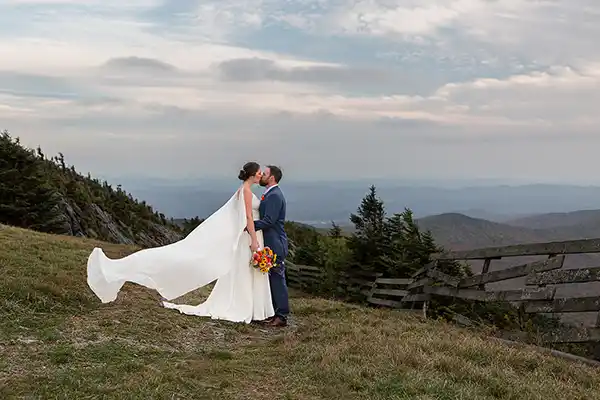 Bride and groom portrait against vibrant Vermont fall foliage landscape at Jay Peak Resort wedding, Burlington Vermont wedding photographer Lindsay Raymondjack