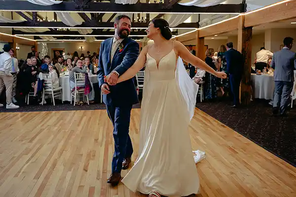 Bride and groom dancing joyfully at Jay Peak Resort Vermont fall wedding reception.