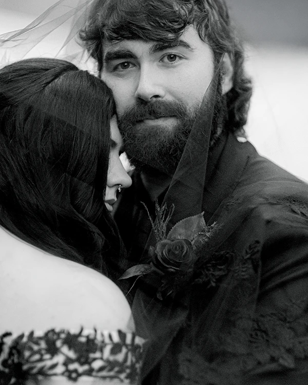 The groom looks at the Vermont wedding photographer