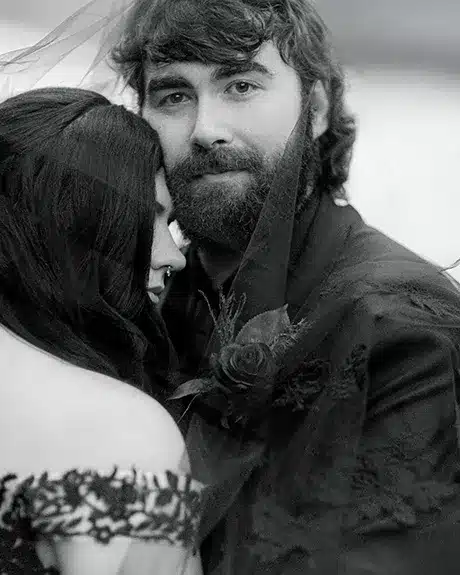 The groom looks at the Vermont wedding photographer