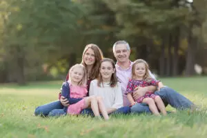 Early Fall Family portrait in a Vermont field with late afternoon light behind the family.