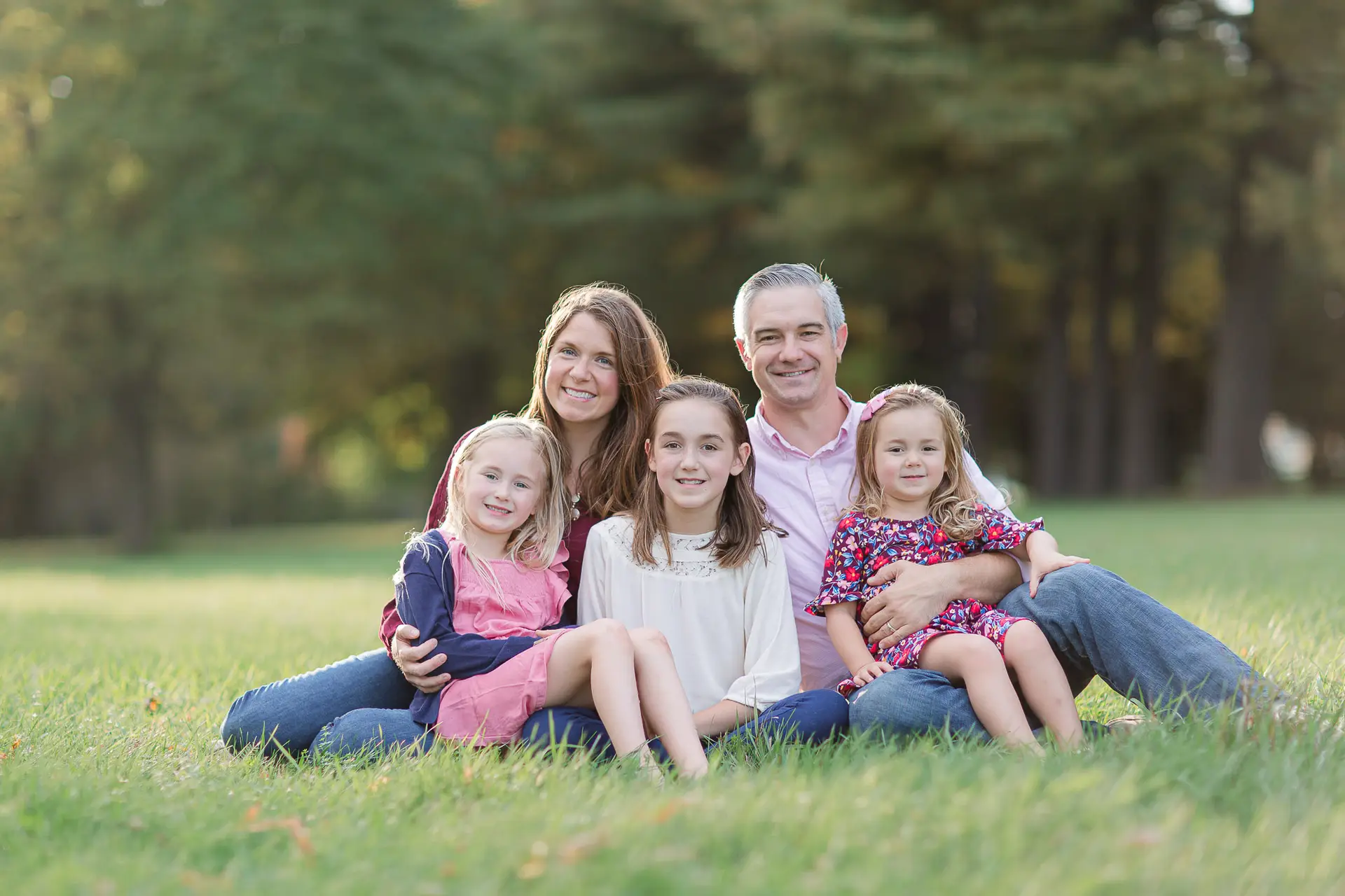 Early Fall Family portrait in a Vermont field with late afternoon light behind the family.