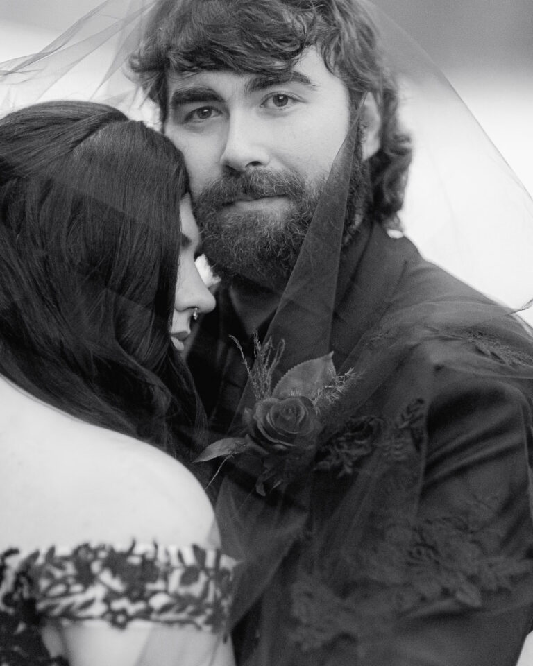 The groom looks at the camera