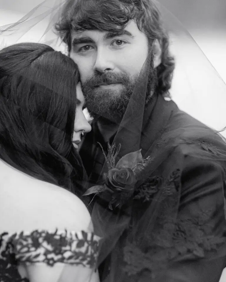 The groom looks at the vermont wedding photographer