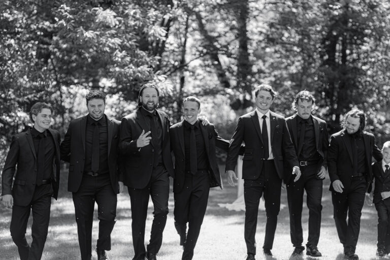 groomsmen walk and laugh