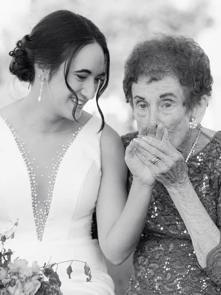 Grandmother kisses the brides hand