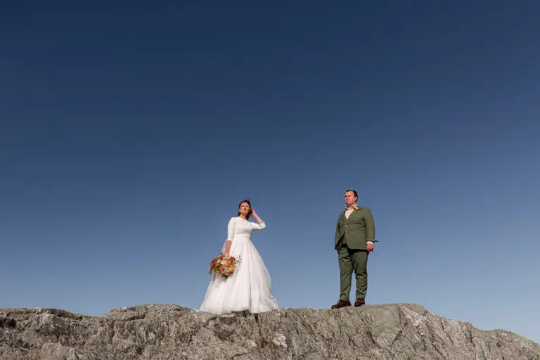 bride and groom on the summit of Jay peak in vermont