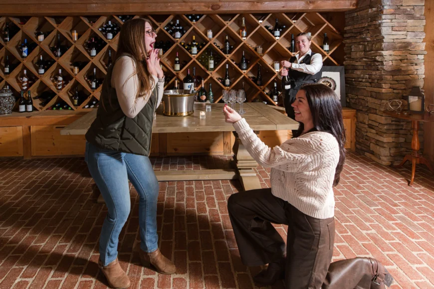 Friends practice marriage proposals in from of the wine rack
