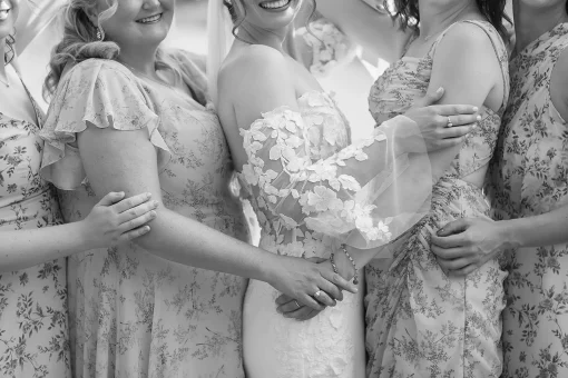 A detail of Bridesmaids holding hands