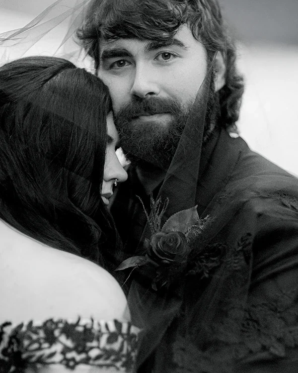 The groom looks at the Vermont wedding photographer