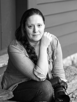 Portrait of Lindsay Raymondjack , vermont wedding photographer sitting on the steps of the Ethan Allen Homestead in Burlington, Vermont Photo by MoHo Photo