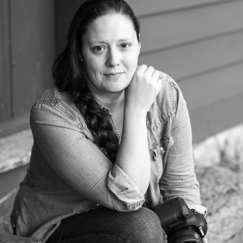 Portrait of Lindsay Raymondjack , vermont wedding photographer sitting on the steps of the Ethan Allen Homestead in Burlington, Vermont Photo by MoHo Photo