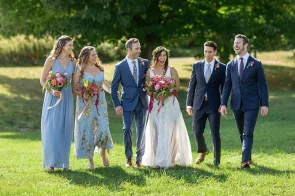 A wedding party walks to the reception at the old lantern