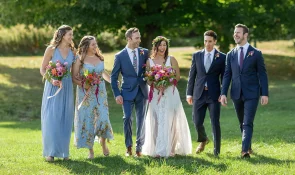A wedding party walks to the reception at the old lantern