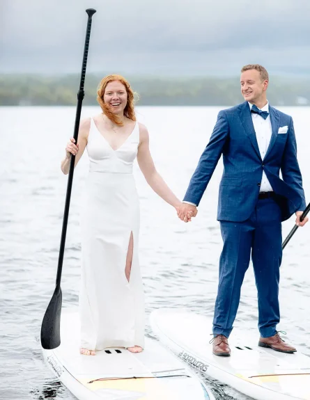 A couple paddle boards on their adventure elopement day in Vermont